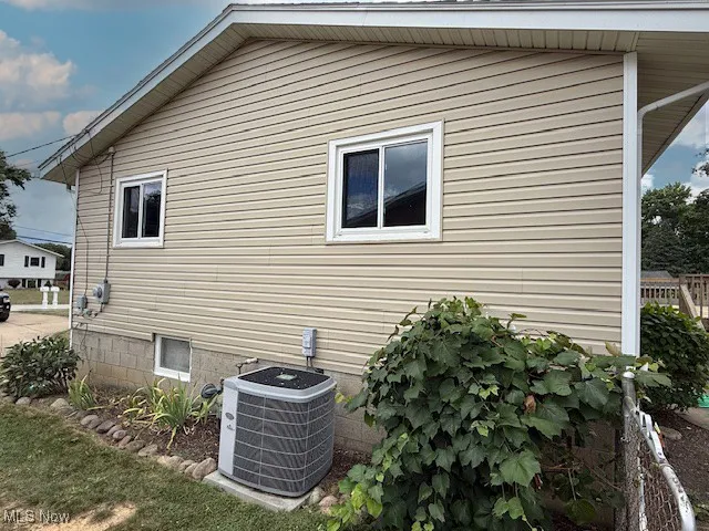 View of property exterior featuring a central AC unit