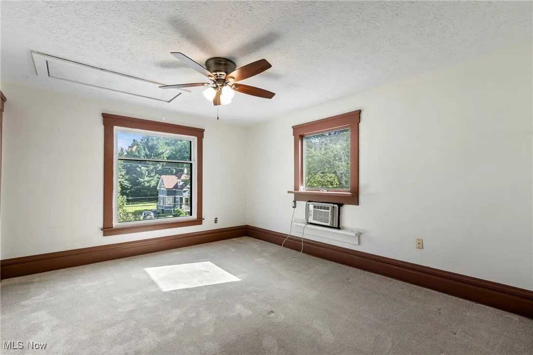 Bedroom at front of home. Wall A/C unit conveys and is supplemental to house A/C