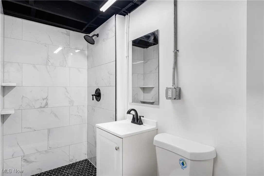 Bathroom featuring vanity and a shower stall