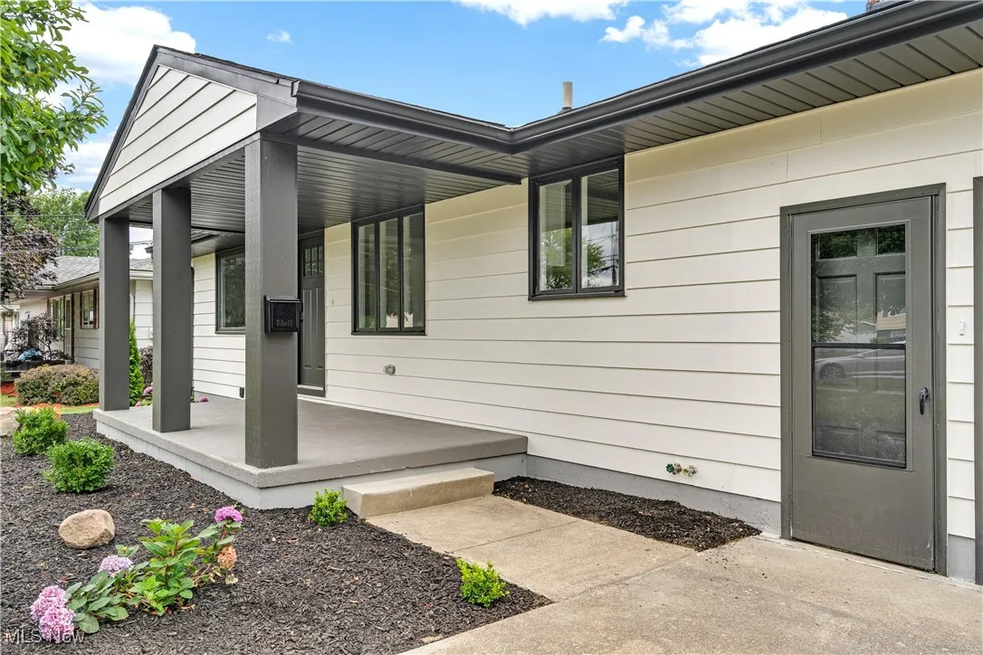 Doorway to property with covered porch