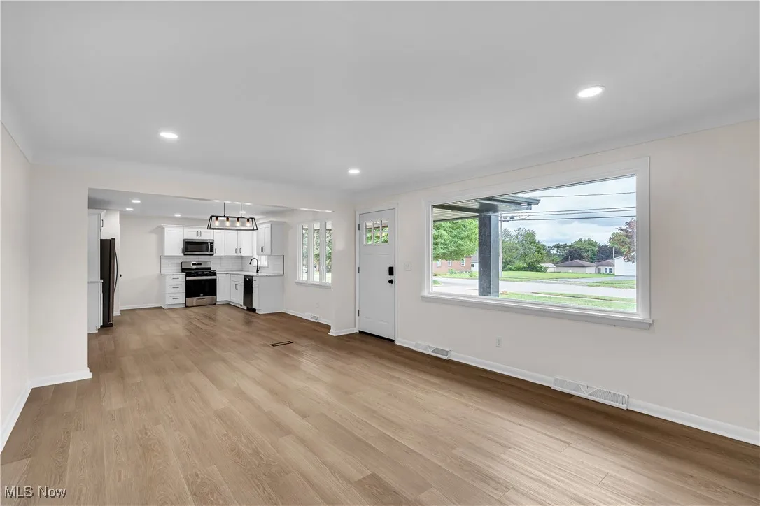 Unfurnished living room with recessed lighting and light wood finished floors