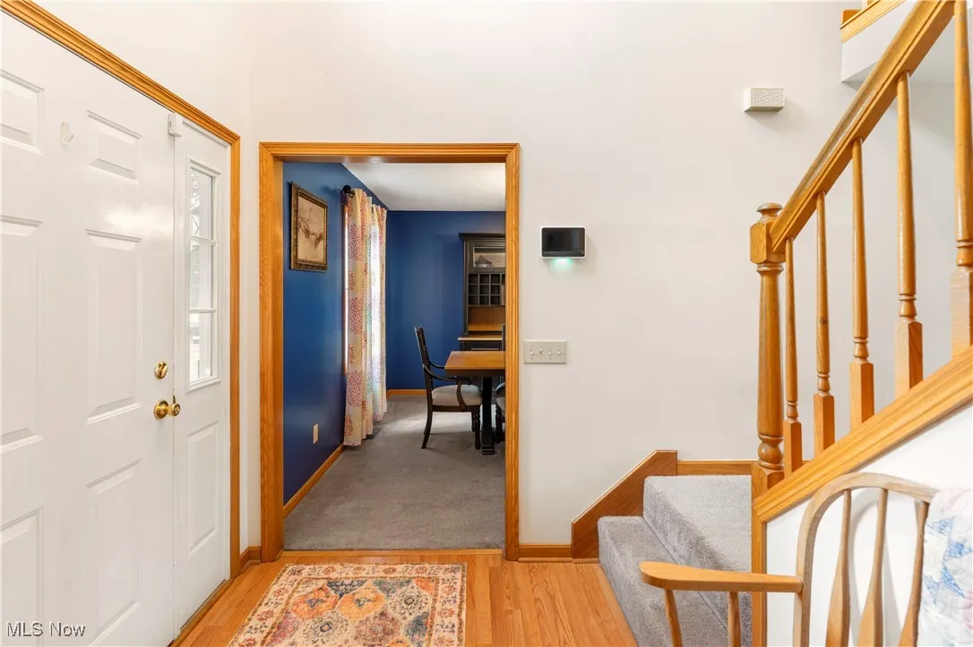 Foyer with stairs and light wood finished floors