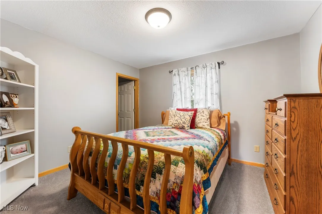 Bedroom featuring carpet and a textured ceiling