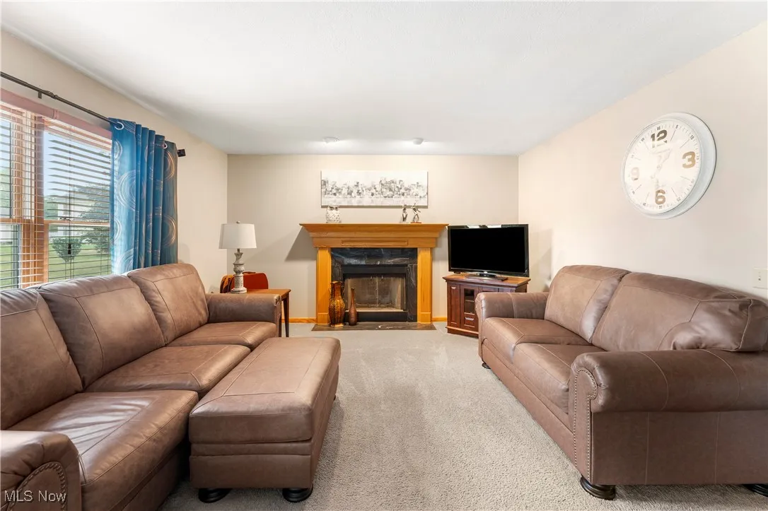 Carpeted living room with a fireplace with flush hearth
