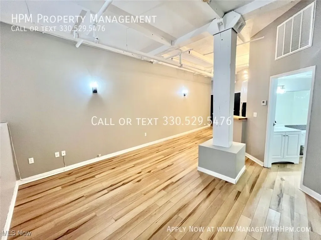 Living room featuring light wood-style flooring and baseboards