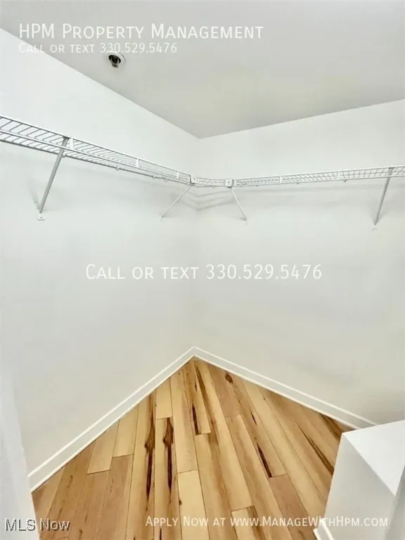 Walk in closet featuring wood finished floors