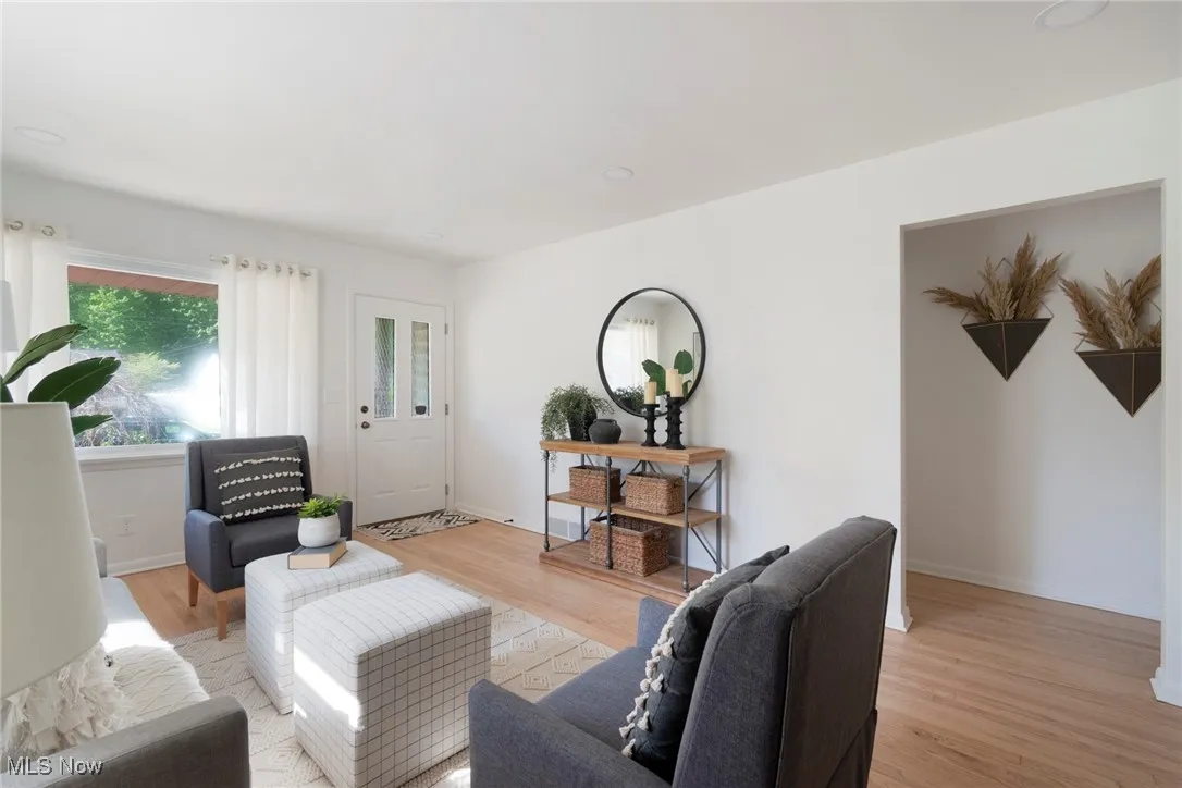 Living room with light wood-style floors and recessed lighting