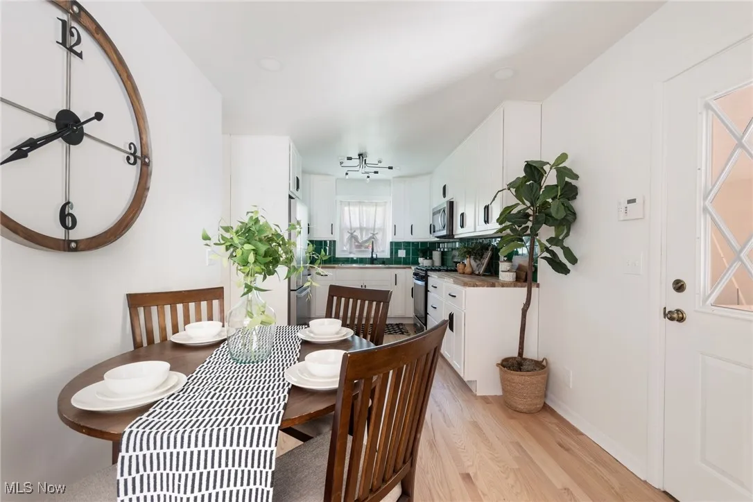Dining room featuring light wood-style flooring and baseboards