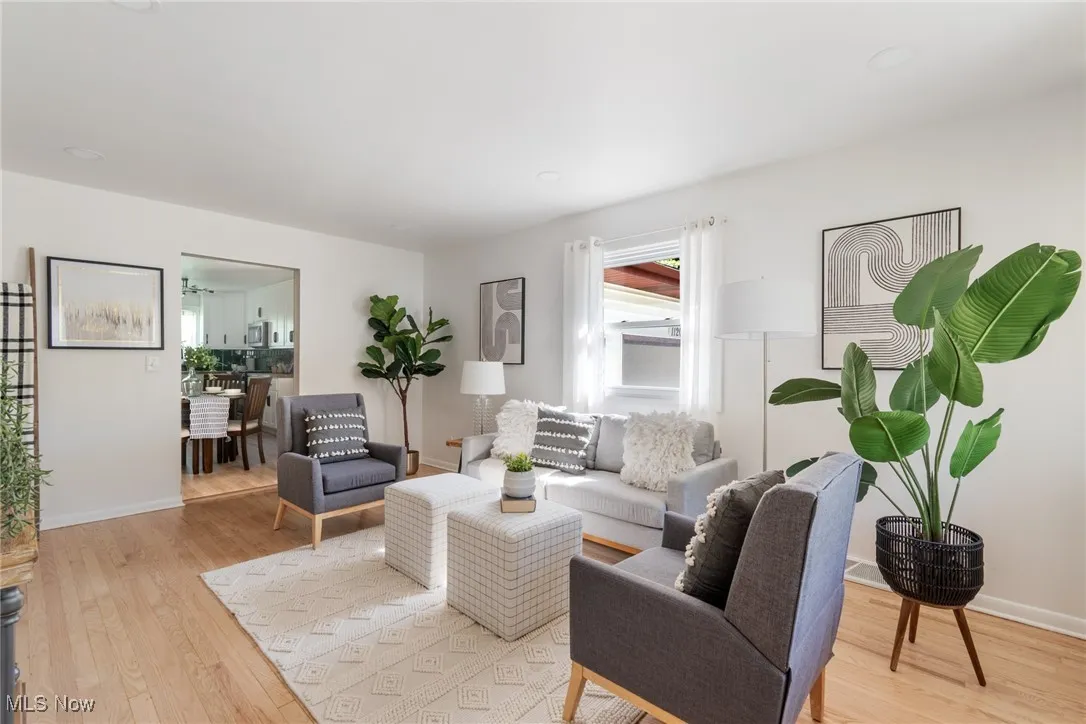 Living room with light wood-style flooring and baseboards