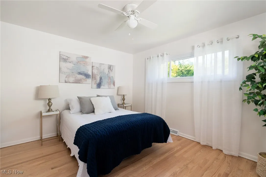 Bedroom with light wood-type flooring and ceiling fan