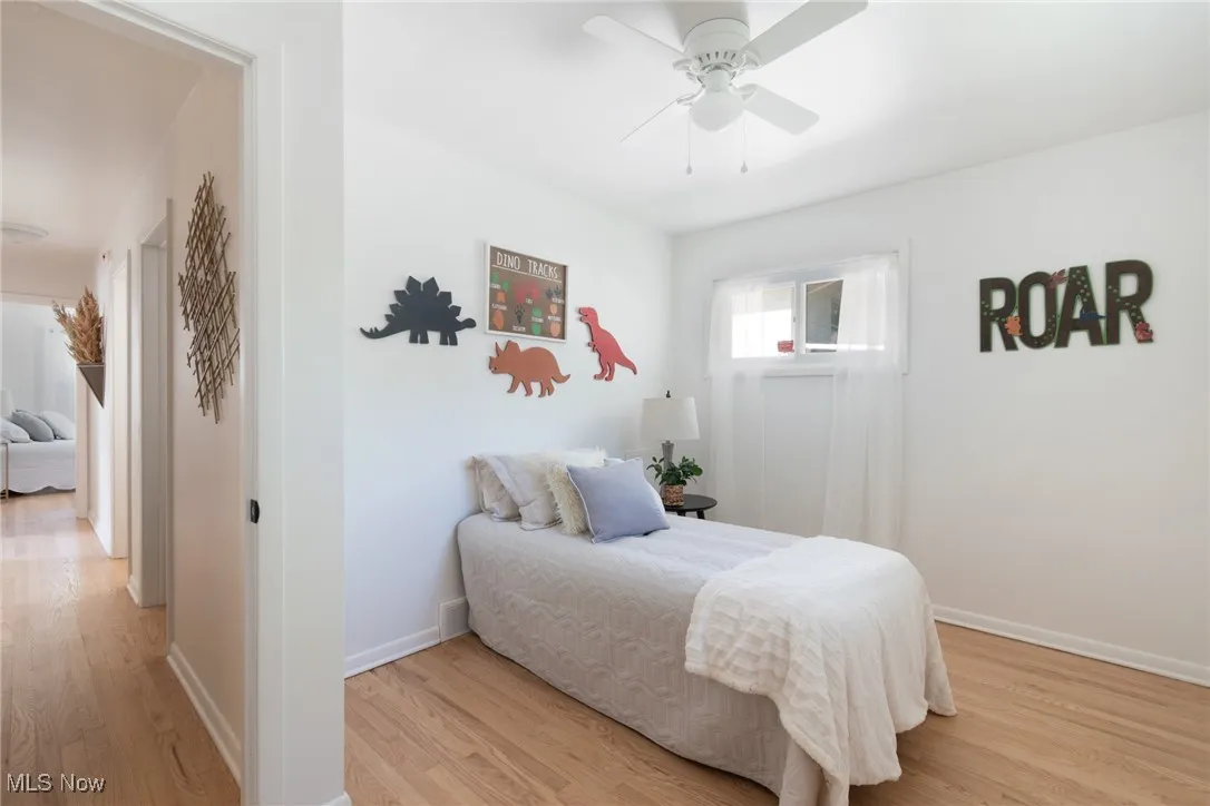 Bedroom with light wood-style flooring and ceiling fan