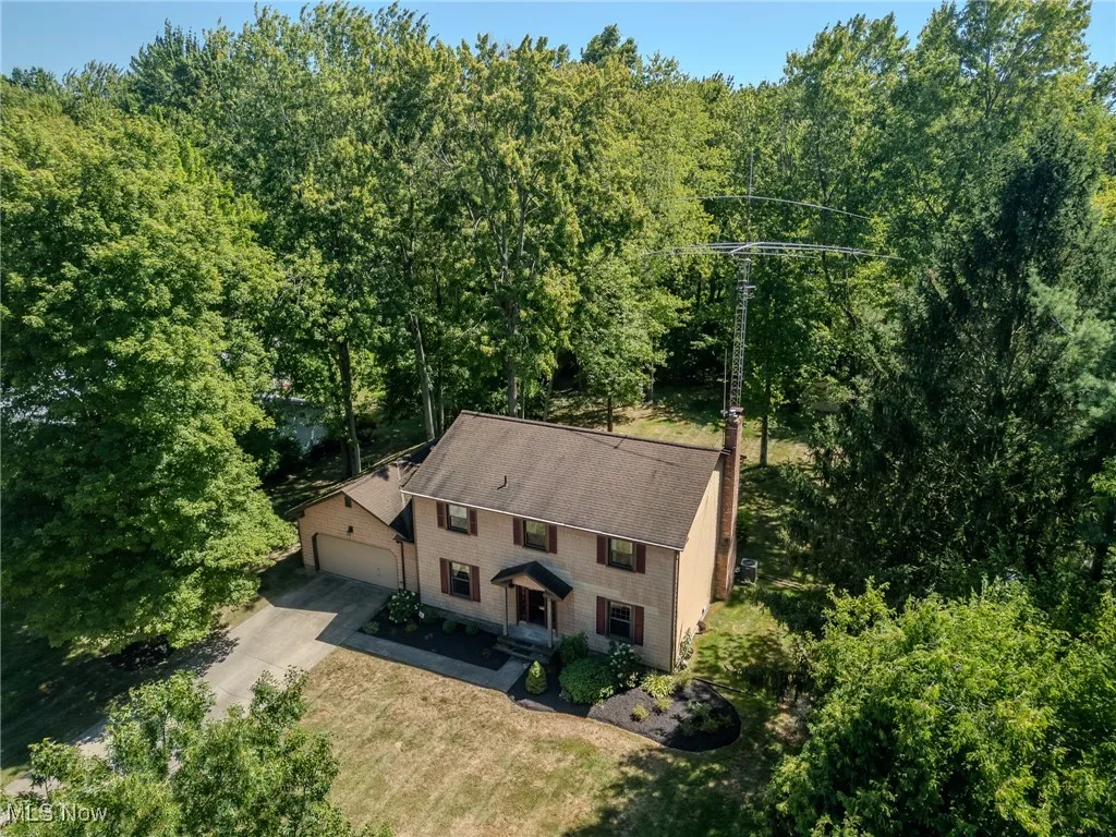 View of subject property with a heavily wooded area