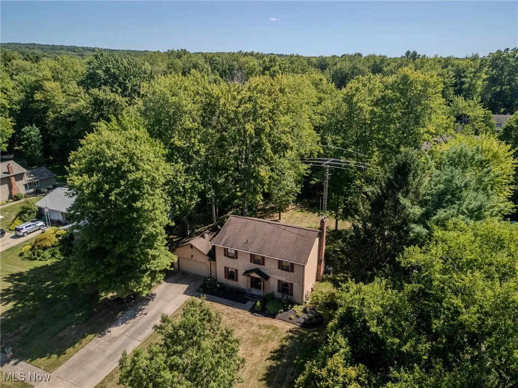 View of subject property with a heavily wooded area