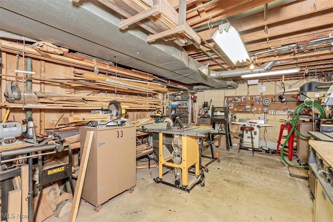 Unfinished below grade area featuring a workshop area