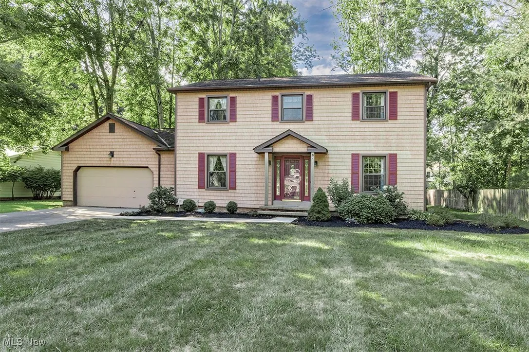 Colonial home with concrete driveway and an attached garage
