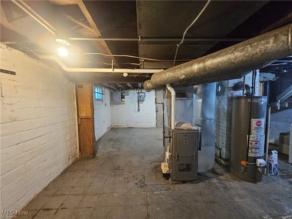 Unfinished basement with newer furnace, hot water heater, and laundry hook-up