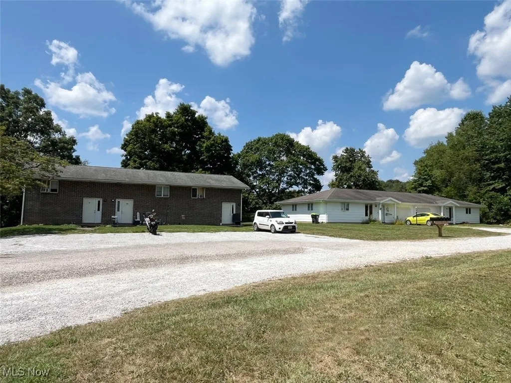 Ranch-style house featuring driveway, a front yard, and brick siding