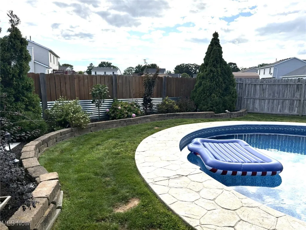 View of swimming pool featuring a fenced backyard and a patio area