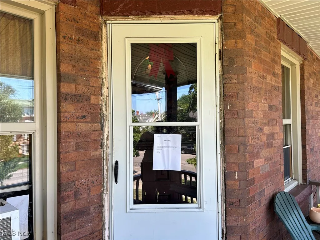 Property entrance with brick siding