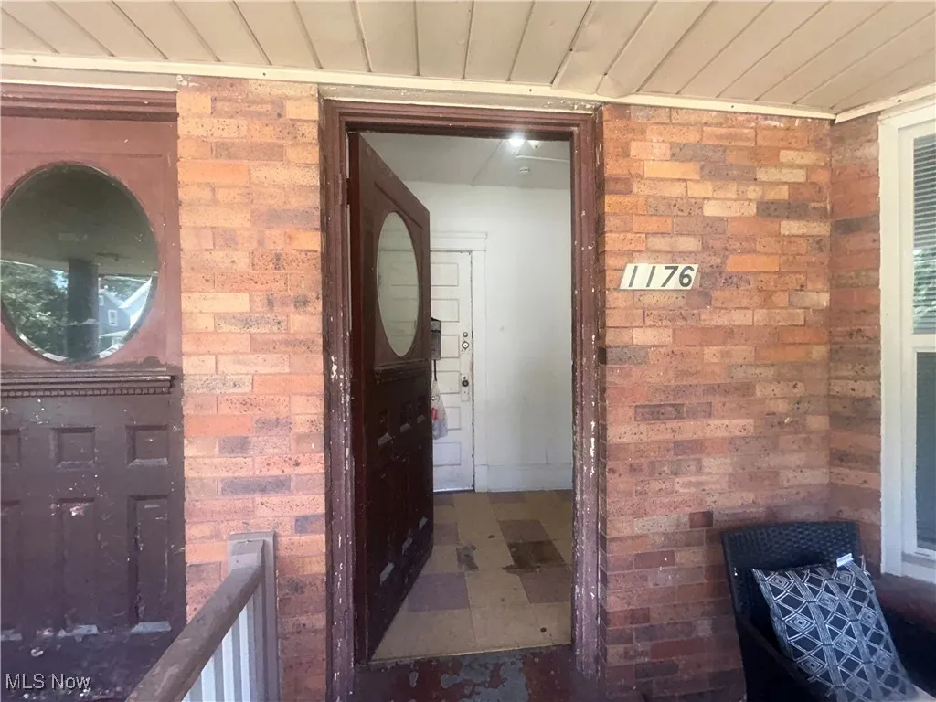 Entrance to property with brick siding