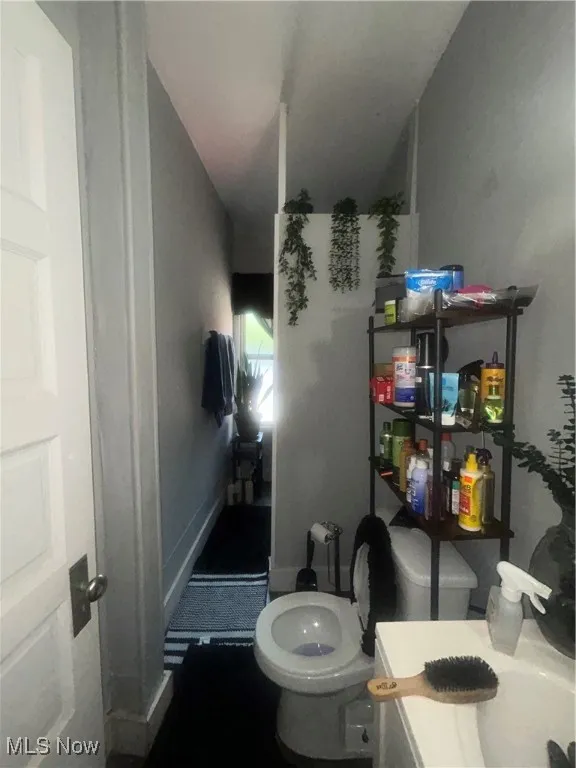 Half bathroom with vanity and toilet