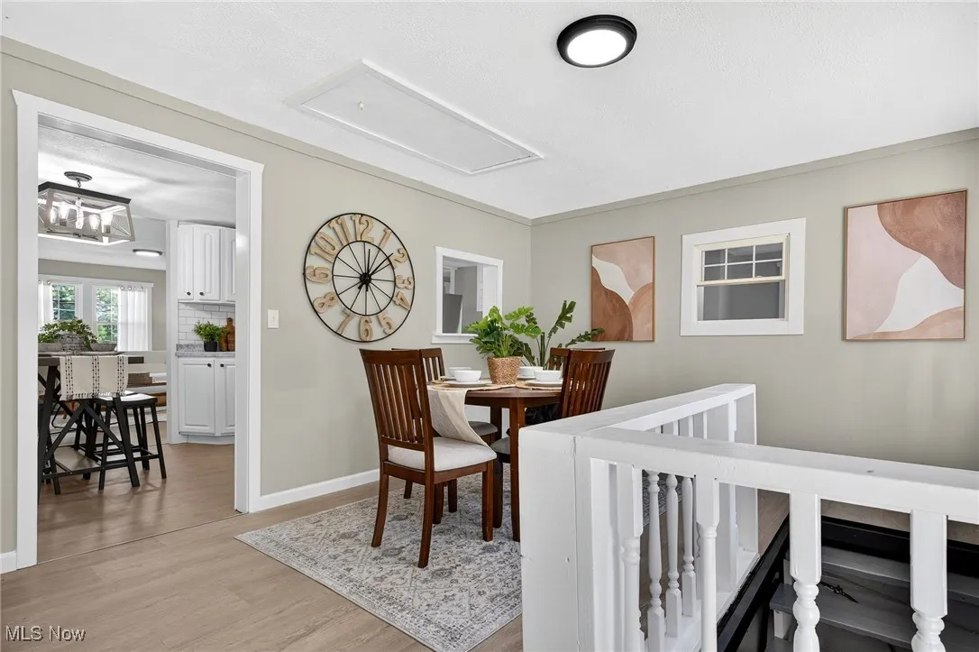 Dining room with light wood-type flooring and baseboards