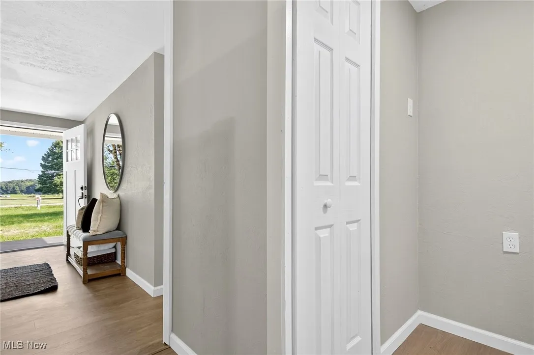 Foyer entrance with light wood-style floors and a textured ceiling