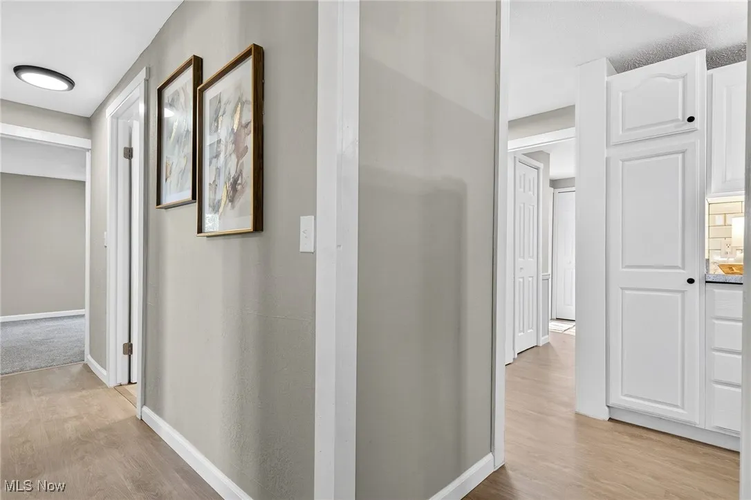 Hall featuring light wood finished floors