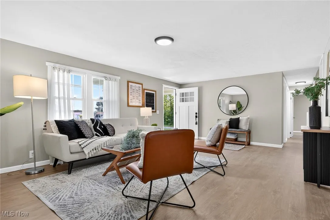 Living room with light wood-style floors and baseboards