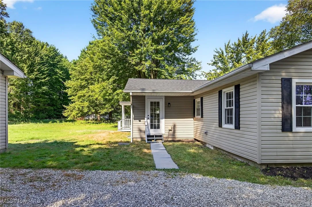 View of front of property with a front lawn and a shingled roof