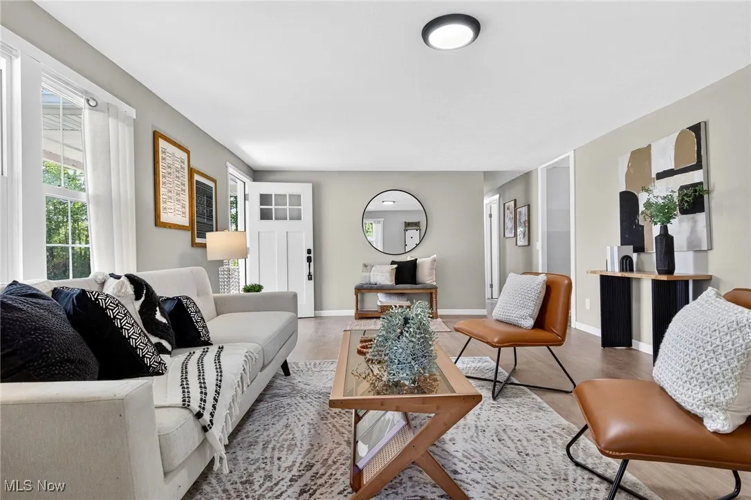 Living area with wood finished floors and baseboards