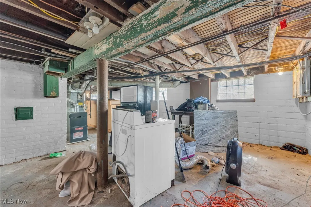 Below grade area with washer / dryer and heating unit