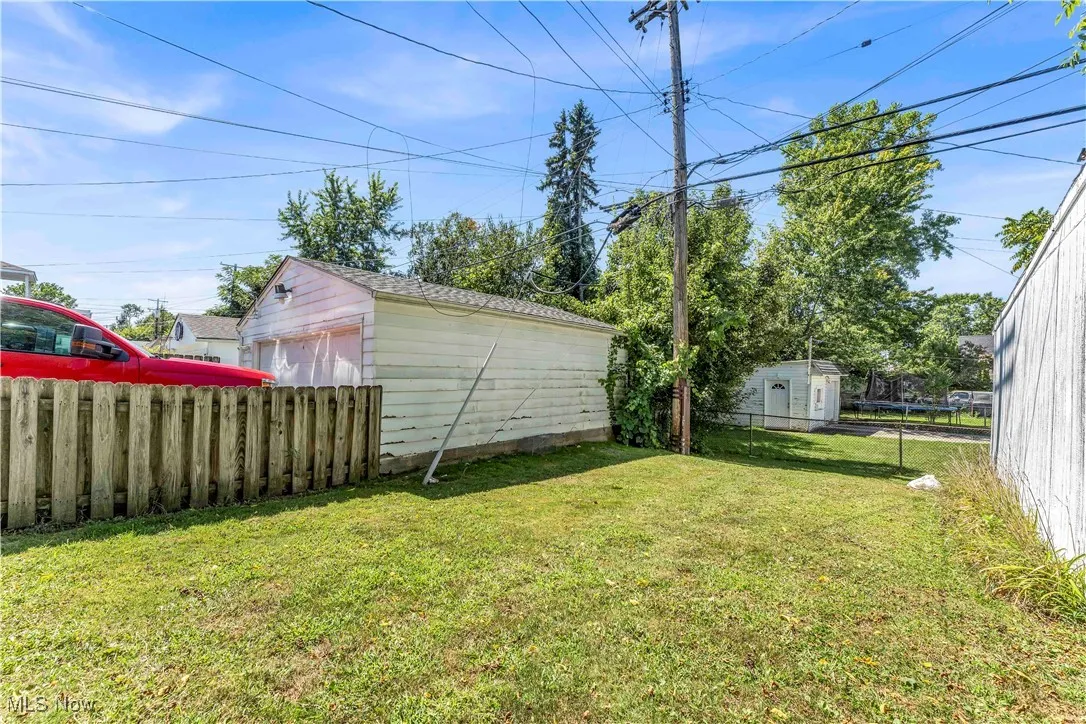 View of yard featuring a garage and an outdoor structure