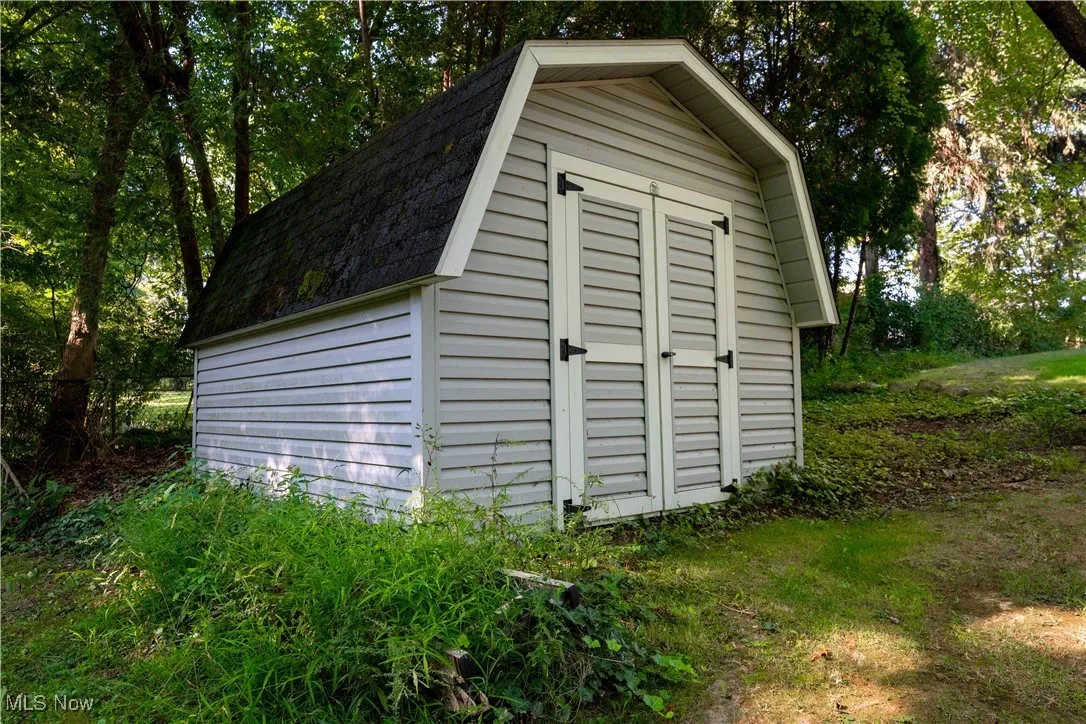 View of shed featuring view of scattered trees