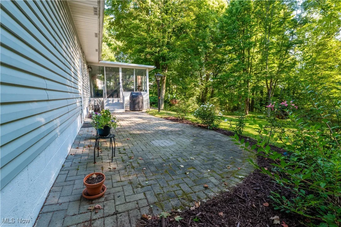 View of patio / terrace with a sunroom, Built in Gas Grill withgas hooked up to home for grilling, and view of the private back yard.