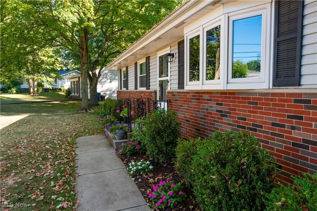 View of home's exterior featuring brick siding and a yard