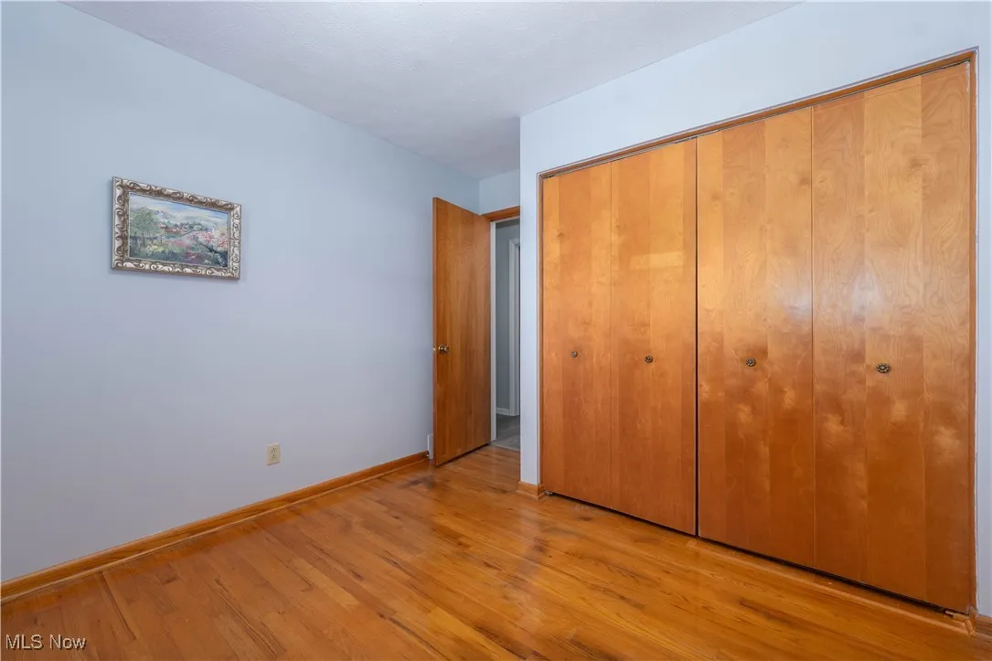 Unfurnished bedroom with light wood finished floors and a closet