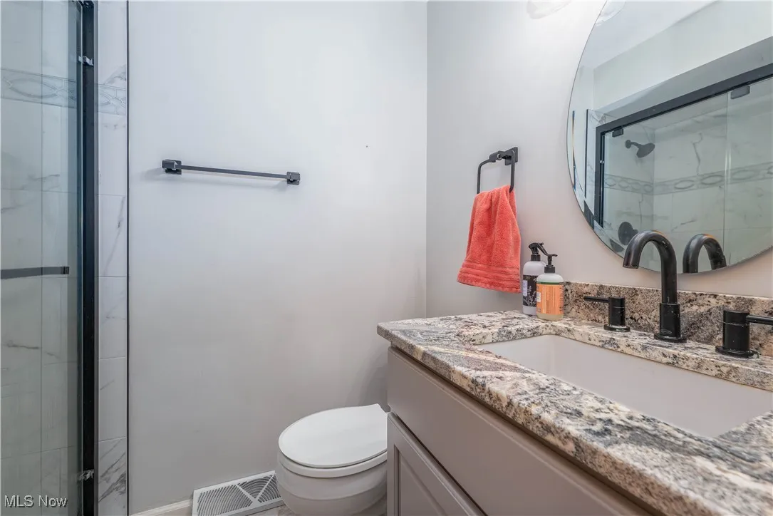 Bathroom with vanity and a stall shower