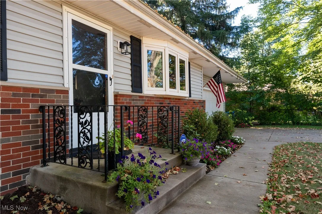 Entrance to property featuring brick siding