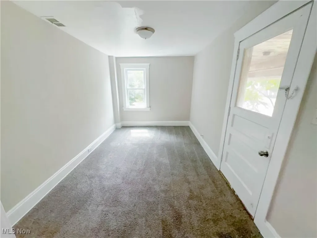 Bedroom featuring carpet floors, baseboards and access to the balcony