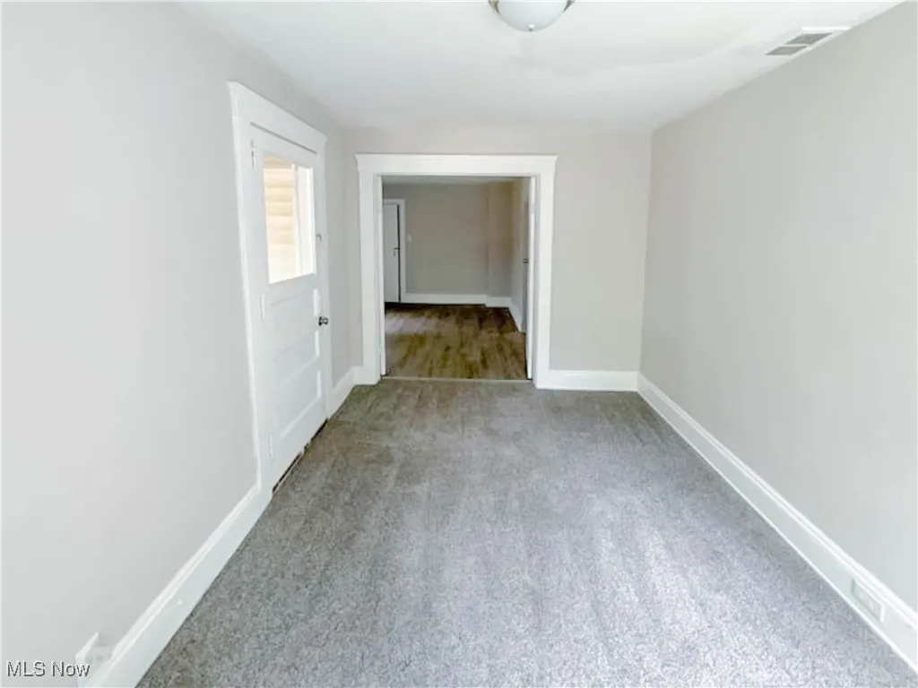 Bedroom featuring carpet floors, baseboards and access to the balcony