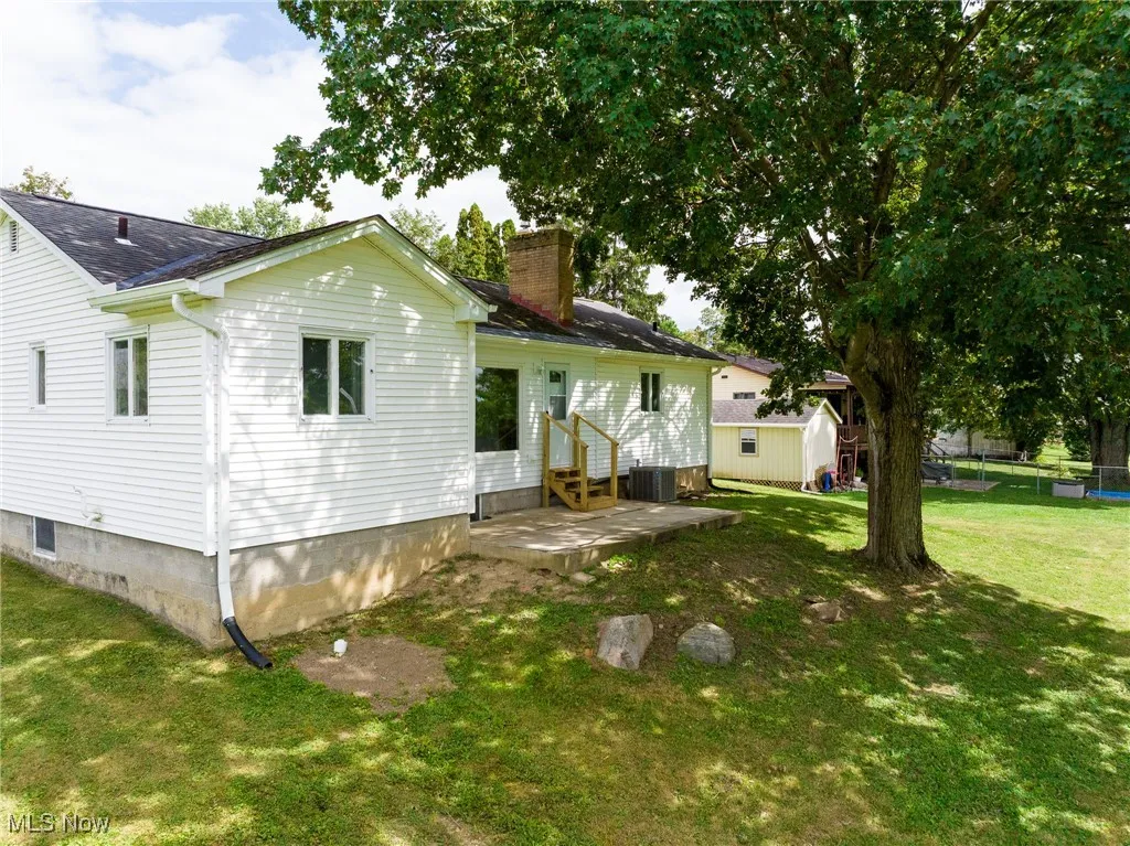Back of property with a patio area and a chimney