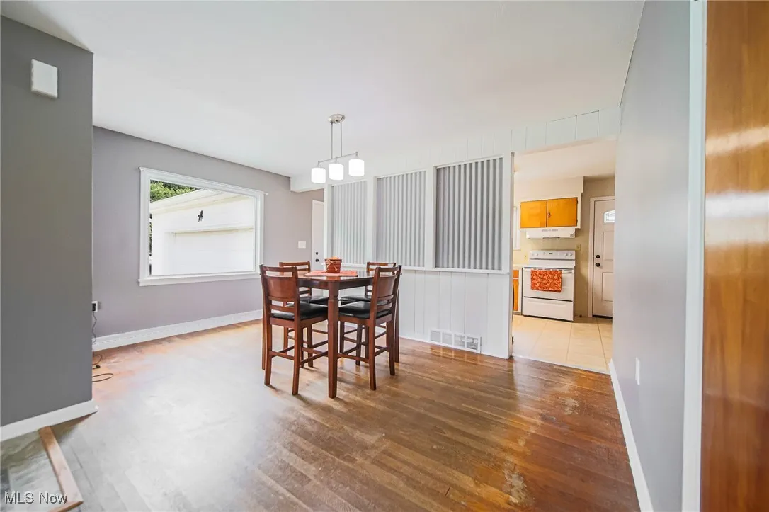 Dining space with light wood-type flooring and baseboards