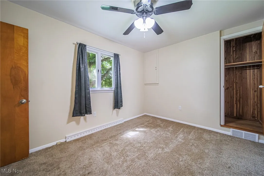 Unfurnished bedroom featuring carpet flooring, and ceiling fan
