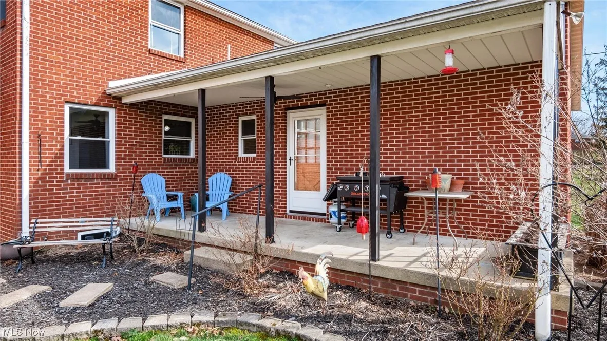 Rear view of property with brick siding