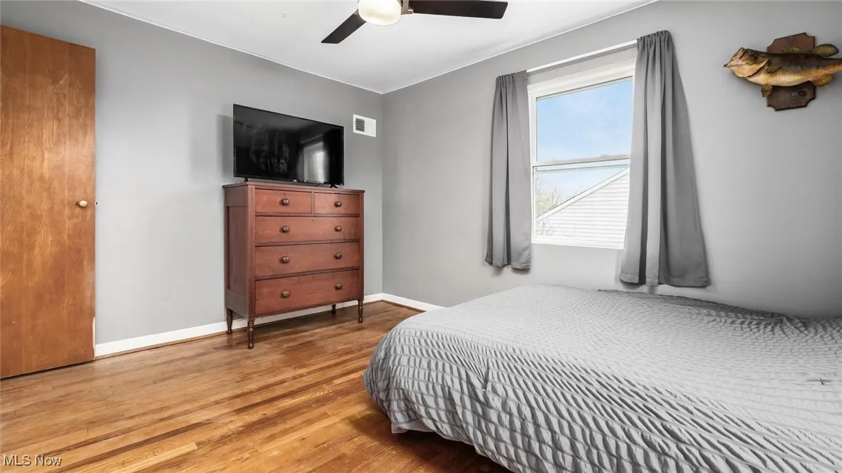 Bedroom featuring wood finished floors and a ceiling fan