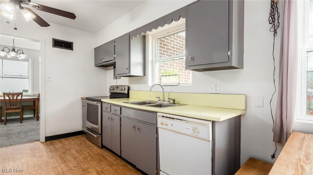 Kitchen with electric range, dishwasher, and healthy amount of natural light