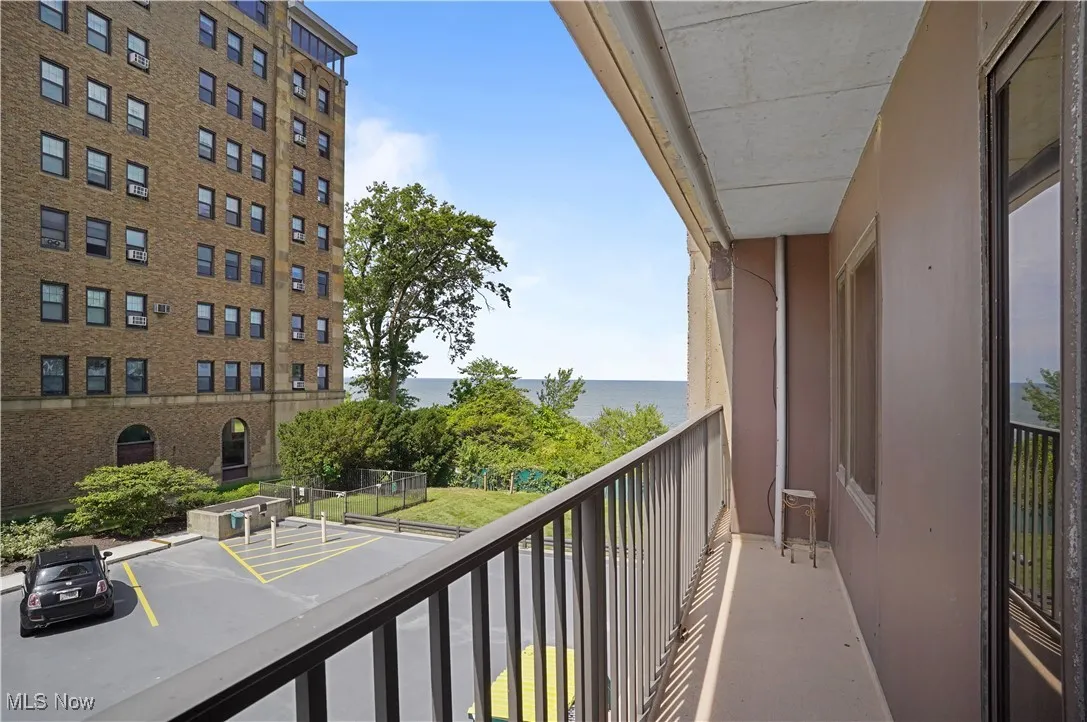 Balcony off primary bedroom featuring a lake view