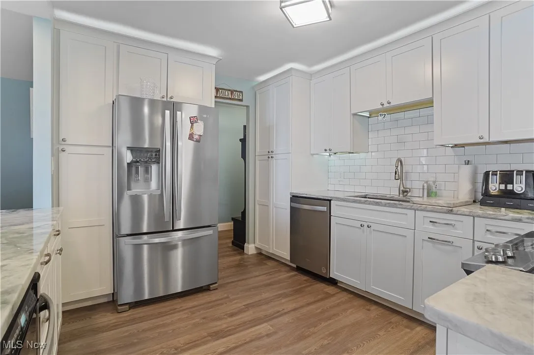 Kitchen with new refrigerator and dishwasher