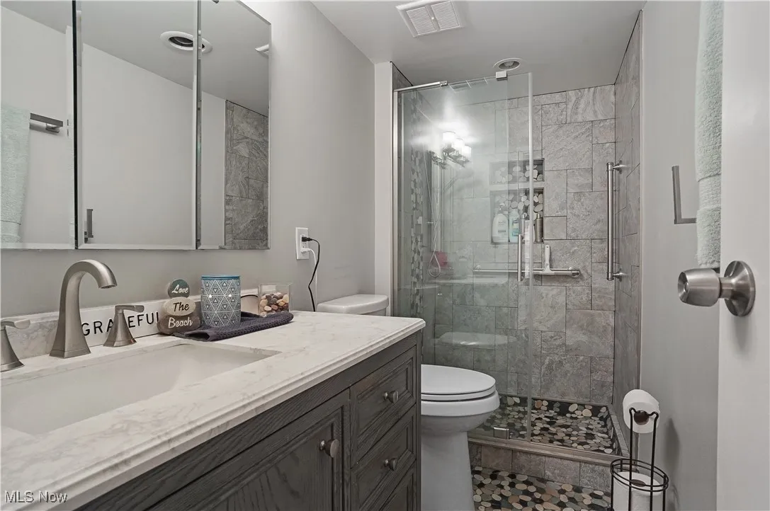 updated Primary full bath with tile floor and tile shower